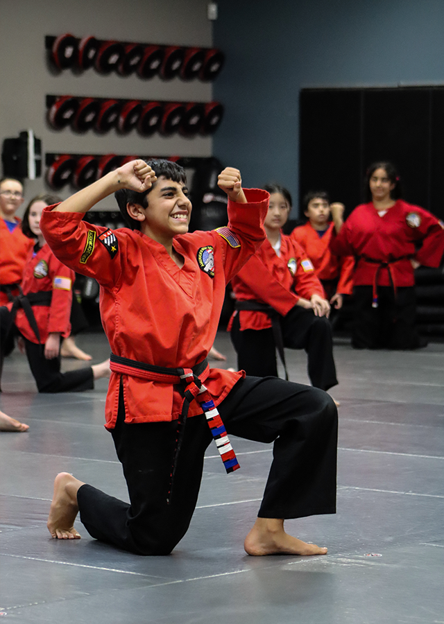 Kids Martial Arts student celebrating a strong self defense performance