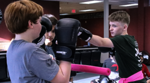 Teen Krav Maga students practicing punch defense techniques