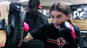 Teen Krav Maga student practicing her punching strikes