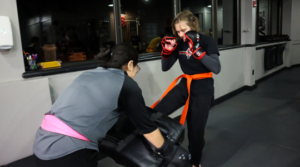 Teen Krav Maga students practicing kicking techniques