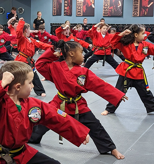 Children practicing group martial arts forms