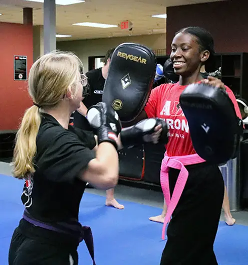 Teen duo working on martial arts techniques