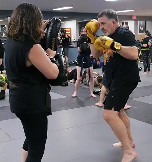 Adult duo practicing Krav Maga strikes