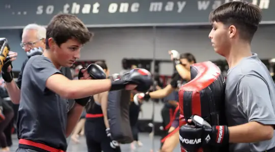 Teens practicing martial arts striking