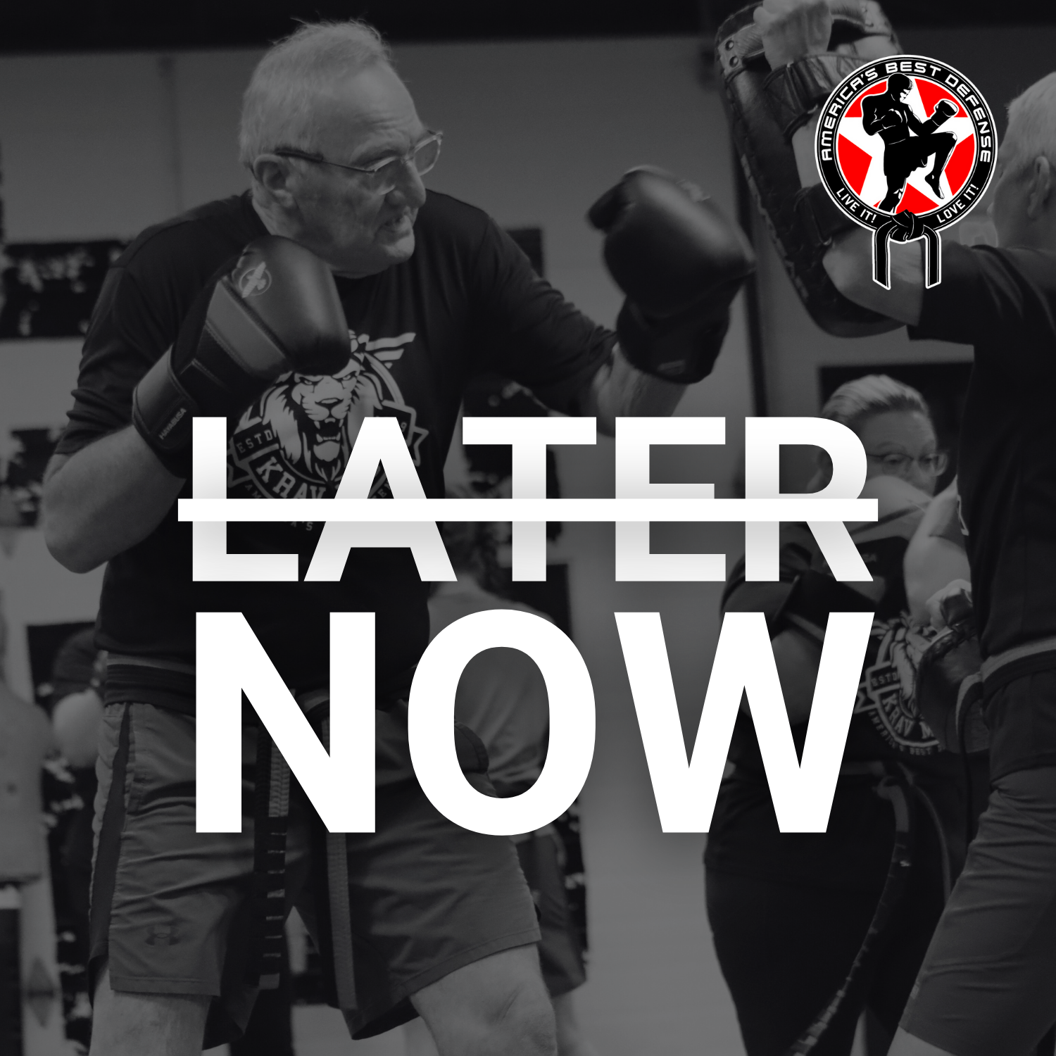 An older adult practicing striking techniques with focus mitts during a Krav Maga class at America's Best Defense. The text overlay reads 'Later' with a strikethrough, followed by 'Now,' emphasizing the importance of taking action today. The ABD logo is featured in the upper-right corner.