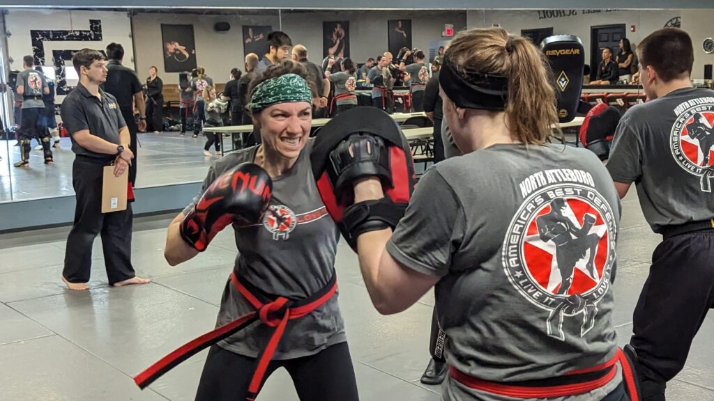 Women doing padwork during a Krav Maga class at America's Best Defense Martial Arts Academy.