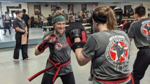 Women doing padwork during a Krav Maga class at America's Best Defense Martial Arts Academy.