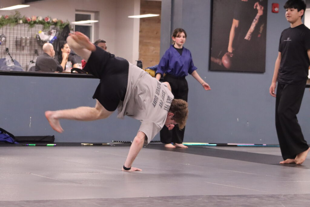 Connor Poirier is mid-trick, with one hand on the ground and the rest of his body in the air at ABD Franklin.