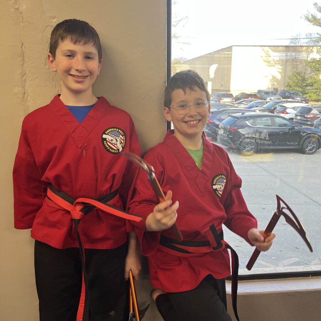 Two of Courtney's sons pose for photo at America's Best Defense Mansfield